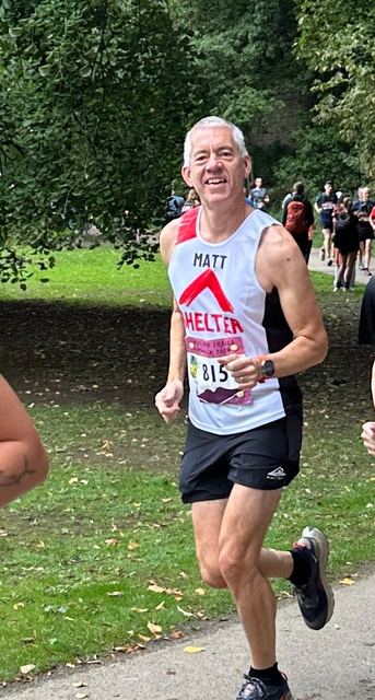 Runner wearing a race number at a park race
