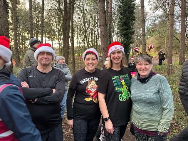Club runners in Santa hats at a festive run