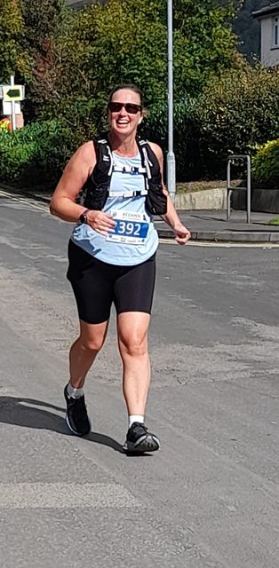 Runner wearing a race number on a road