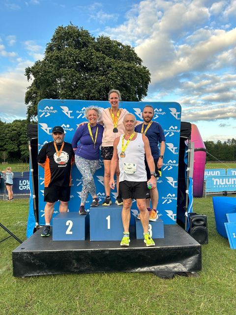 Runners on the podium at a race event