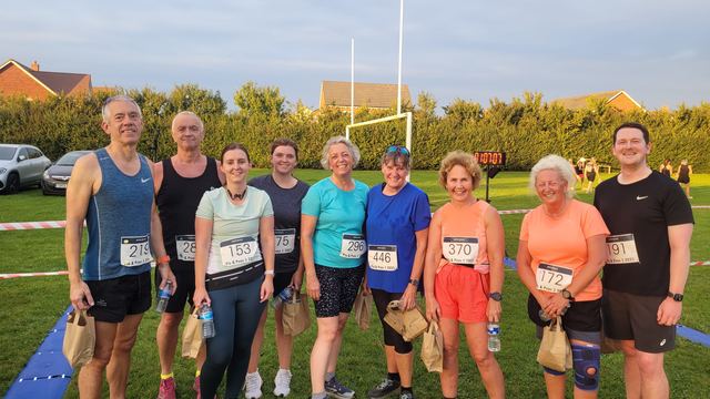 Group of club runners after a session on a sports field