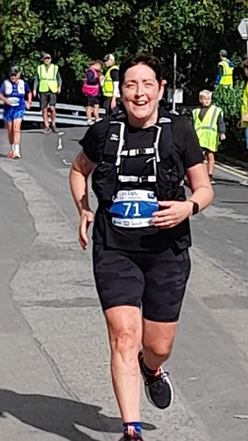 Runner in a race vest on a road